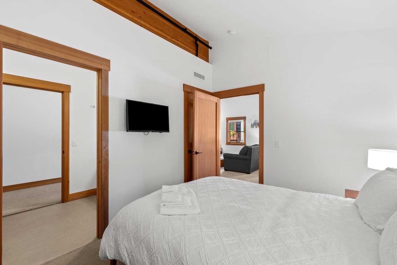 Bedroom with Queen Sized Bed and TV.